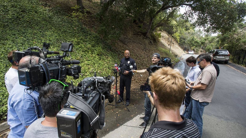 LA Police Sgt Barry Montgomery talks to media outside the home of Demi Moore where a man died in her pool 