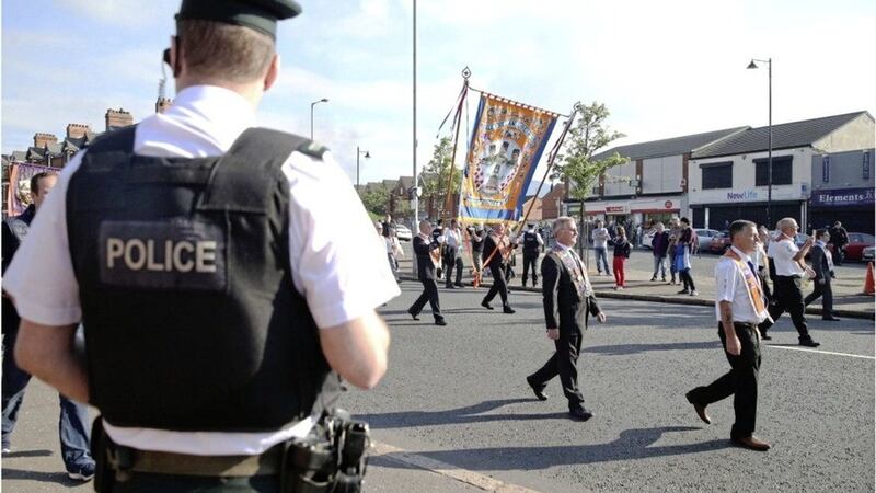 Orange Order members march past the Ardoyne shops in north Belfast in 2017. Picture by Hugh Russell