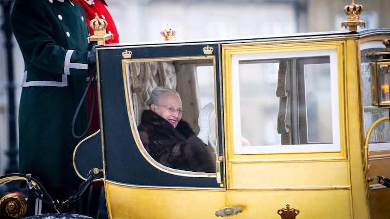 Denmark’s Queen Margrethe is escorted by the Hussar Regiment as she rides in a horse-drawn coach from Christian IX’s Palace, Amalienborg, to Christiansborg Palace in Copenhagen on Thursday (Emil Nicolai Helms/Ritzau Scanpix via AP)