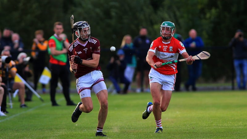 Cushendall’s Scott Walsh plays the ball away as Loughgiel’s Paul Boyle closes in during in yesterday’s Antrim SHC match at Dunsilly Picture: Seamus Loughran