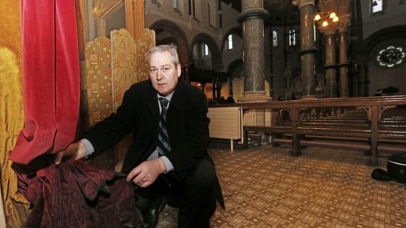 Diocesan property administrator, David Gantley, surveys the damage to the curtains after the arson attack in St Patrick&#39;s Church in Belfast. Picture by Hugh Russell 