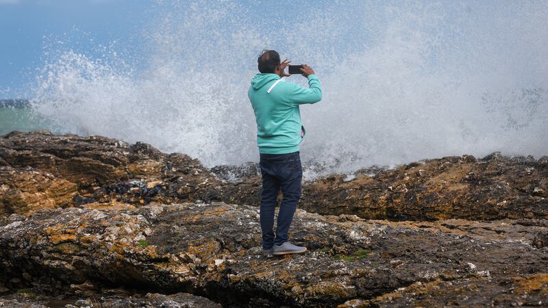 A member of the public photographs the waves on the stormy Antrim Coast at the weekend. Picture by Mal McCann