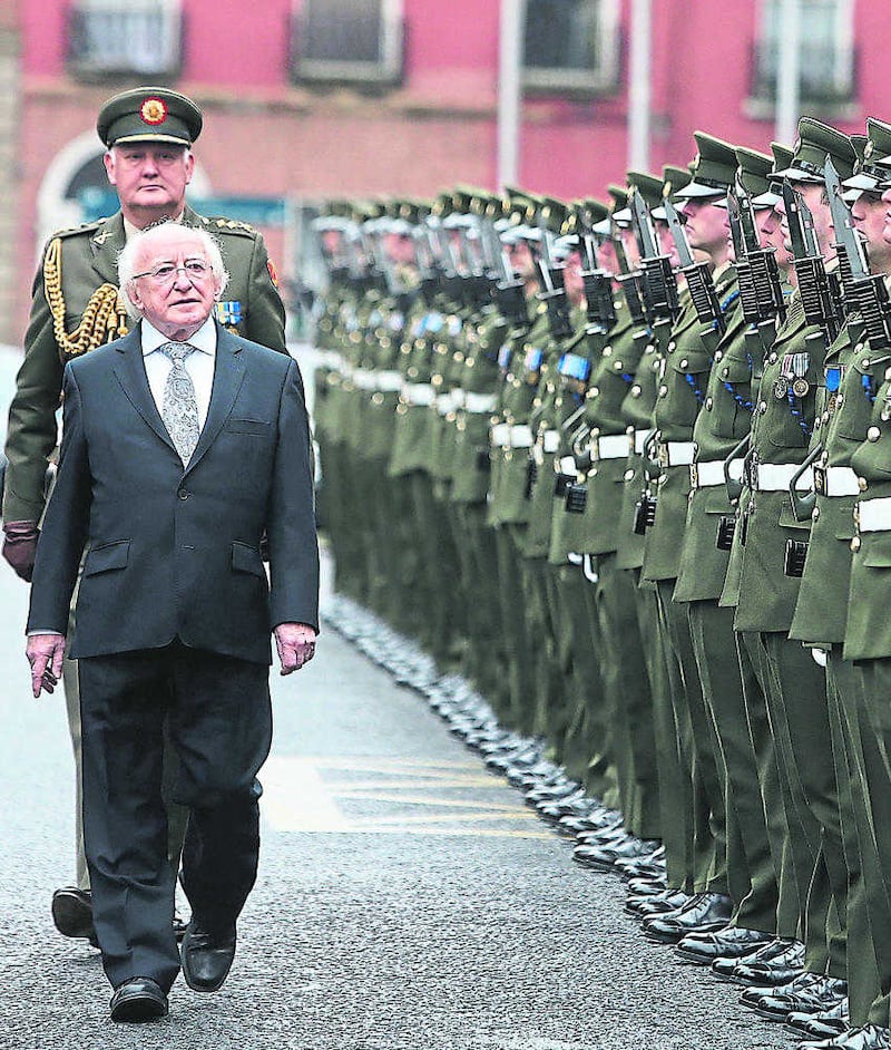 President Michael D Higgins inspects troops of the Irish Army. His father John was in the East Clare IRA in the War of Independence 