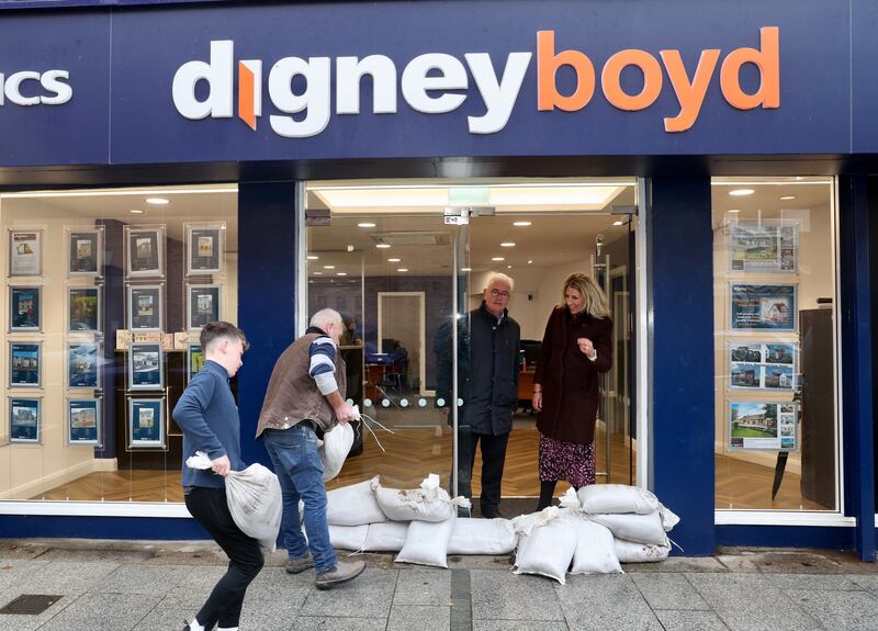 Bronagh Boyd and Patrick O’Reilly from Digney Boyd estate agents in Hill Street watch as sandbags are delivered to protect the property. PICTURE MAL MCCANN