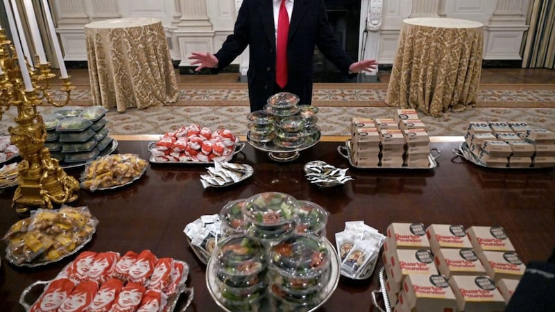 President Donald Trump talks to the media about the table full of fast food in the State Dining Room of the White House. Picture by Susan Walsh/AP 