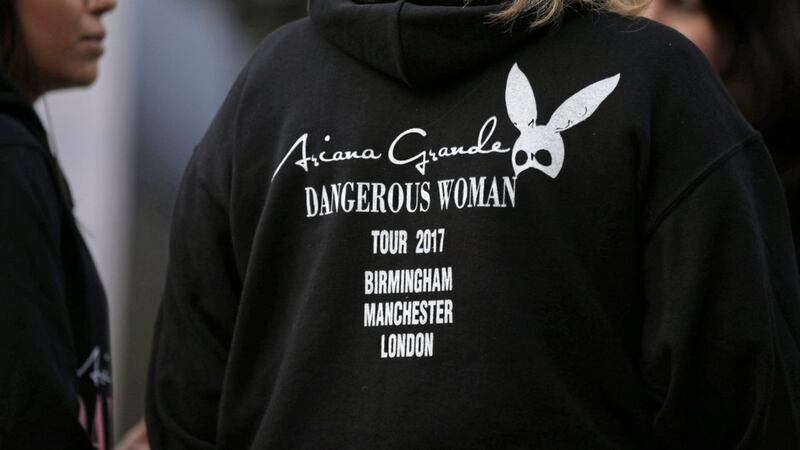 A fan wears an Ariana Grande hoodie near the Manchester Arena after last month&#39;s suicide bombing 