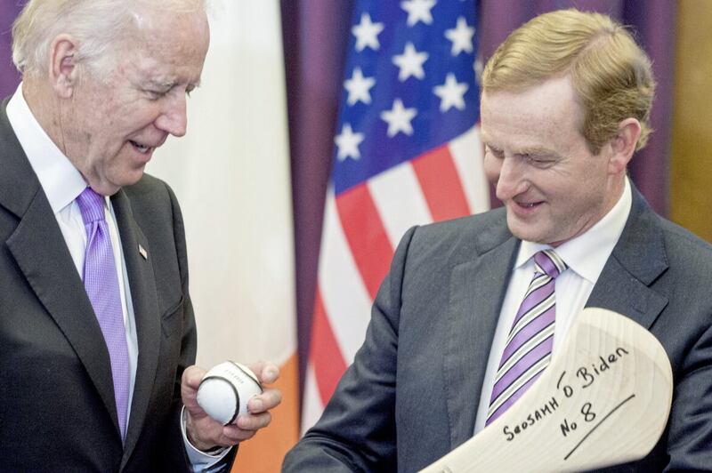 Former Taoiseach Enda Kenny welcomes then US Vice-President Joe Biden to Government Buildings, Dublin at the start of a six-day visit in 2016 and gives him a gift of a hurling stick and sliothar, with Mr Biden&#39;s name written in Irish. Picture by Barry Cronin/PA Wire 