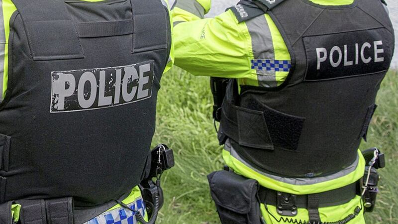 Officers were inside their police car in Larne when youths wearing ski masks began pelting it with stones 