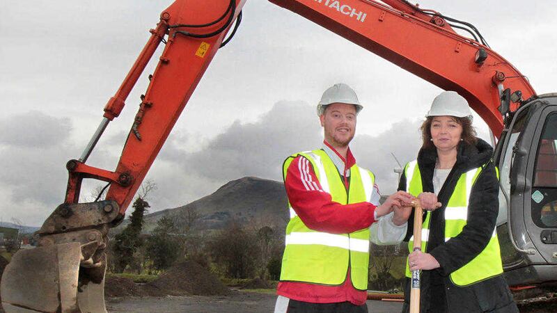 Sports Minister Car&aacute;l N&iacute; Chuil&iacute;n and Dungiven athlete Ryan O&#39;Connor cutting the first sod at the new Dungiven sports complex. Picture by Margaret McLaughlin 
