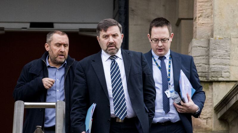 Minister for Health Robin Swann (centre) of the UUP leaving Stormont Castle with DoH Director of Communications David Gordon (left) and UUP staff member Mark Ovens (right), leave Stormont Castle after a meeting to discuss the Government's financial offer to support the power sharing deal&nbsp;