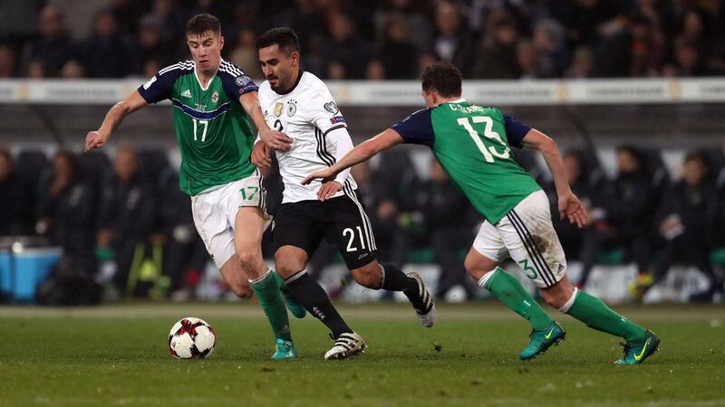 Germany's IIkay Gundogan battles for the ball with Northern Ireland's Paddy McNair (left) and Corry Evans (right) during the 2018 FIFA World Cup Qualifying match at the HDI Arena, Hannover&nbsp;