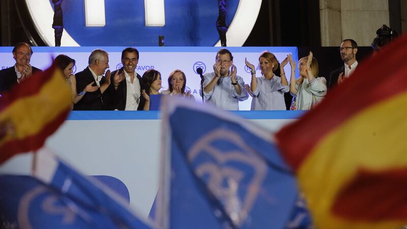 Spain's acting Primer Minister and candidate of Popular Party Mariano Rajoy, centre, celebrates with party members the results of their party, during the national elections in Madrid, Spain. Picture by Paul White, Associated Press