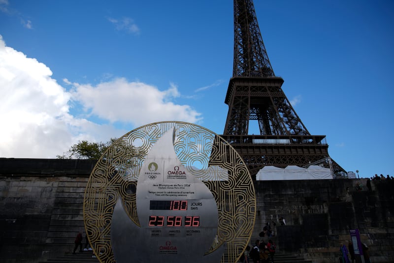 The countdown clock, set up on the banks of the River Seine river in front of the Eiffel Tower, reads 100 days before the Paris 2024 Olympic Games opening ceremony (Christophe Ena/AP)