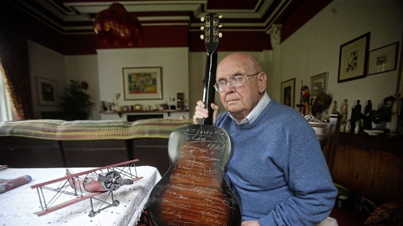John C Hewitt, writer and aviation historian, with the guitar that was by signed by RAF personnel before they left for the Second World War. Picture by Mal McCann 