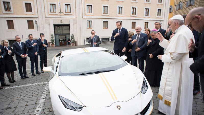 Pope Francis blesses a Lamborghini donated to him by the luxury sports car maker, at the Vatican, on Wednesday. Picture by L'Osservatore Romano, Pool Photo via Associated Press&nbsp;