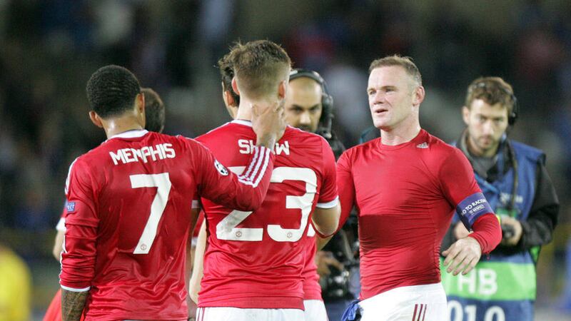 Manchester United&#39;s Wayne Rooney, right, Luke Shaw, centre, and Memphis Depay leave the pitch at the end of the Champions League play-off round, second leg soccer match at the Jan Breydel Stadium in Brugge, Belgium  