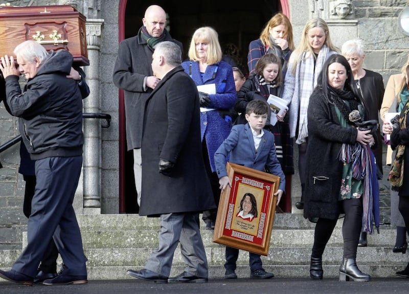 A young boy carriess a picture of Bobby Sands at the funeral of Rosaleen Sands. Picture Mal McCann
