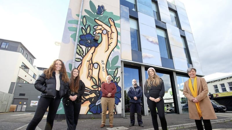 Climate change activist Rosalind Skillen, Lydia Neish from Tear Fund NI, Rev Brian Anderson from East Belfast Mission, John Nicholson from East Belfast Mission, artist Danni Simpson and Green Party leader Clare Bailey at a new climate change mural on the Skainos Building in east Belfast. Picture by Mal McCann 