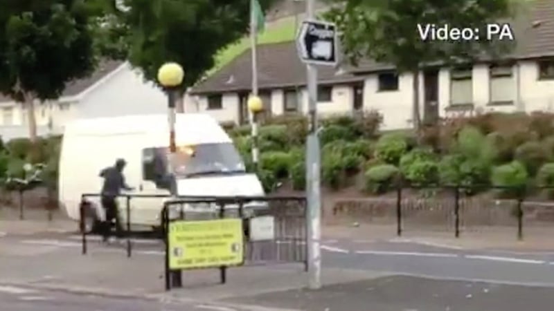 Footage has emerged of a hooded man throwing a petrol bomb at a van in Derry at close range 