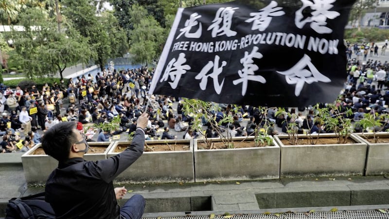 A pro-democracy supporter waves a flag during a rally in Hong Kong on Monday. Picture by Vincent Thian/AP 