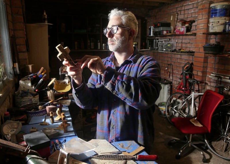 Belfast author Jim Deeds in his workshop, where he has been making crosses from reclaimed wood. Picture by Mal McCann
