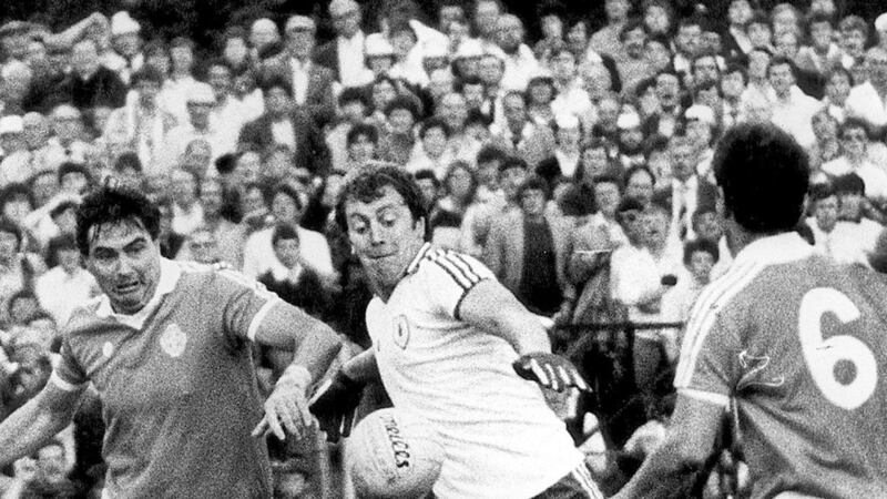 Tyrone legend Frank McGuigan and his family have been honoured in the GAA President's Awards. Frank Snr is shown in action against Armagh's Joe Kernan.