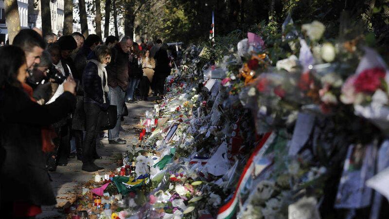People pay respect to the victims in front of the Bataclan concert hall in Paris 