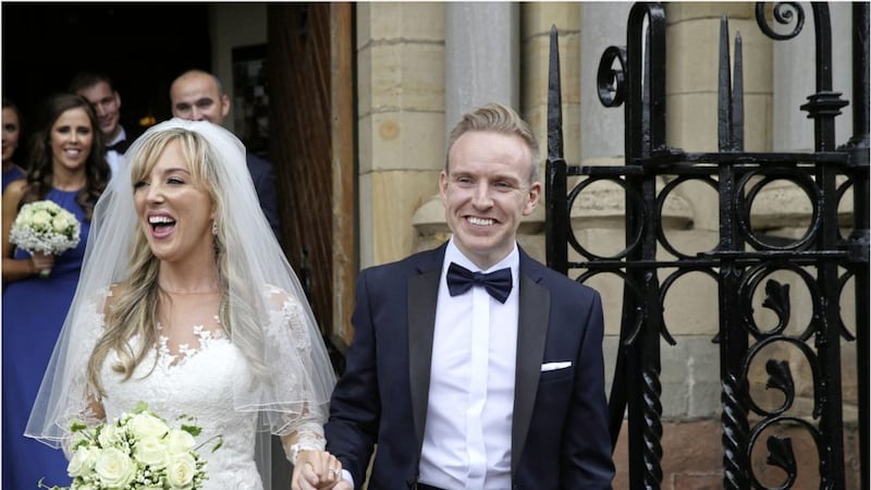 Former GAA Ulster Council official Ryan Feeney and his new bride pictured outside St Patrick&#39;s Church in Belfast yesterday 