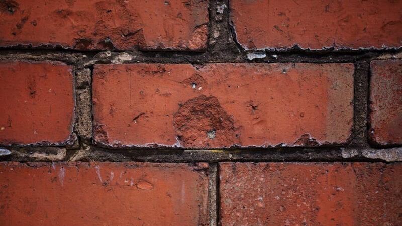 An original wall with what could be bullet holes is seen by an Air Training Corps building in Bamber Bridge (AP)