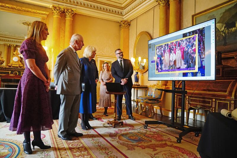 The King and Queen are shown the digital version of the Coronation Roll