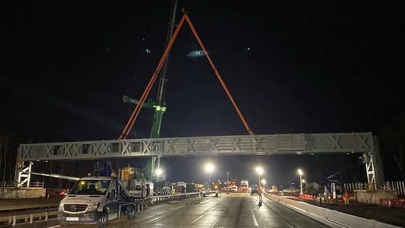 A gantry being installed overnight on a closed section of the M25 motorway in Surrey