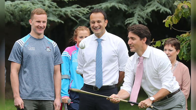 Canadian Prime Minister Justin Trudeau, watched by Dublin GAA footballer Ciaran Kilkenny, tries out a hurling stick in the grounds of Farmleigh House in Dublin, after holding a press conference with Taoiseach Leo Varadkar. Picture by&nbsp;Niall Carson, PA Wire