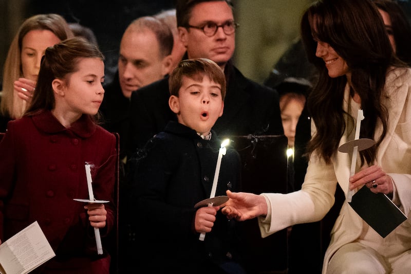Louis blows out a candle during the Westminster Abbey carol service staged by Kate