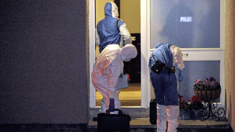 Police examine the house where Robin McMaster died in Ballymena last week 