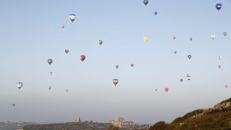 Some of the 100 balloons taking part in a World Record attempt fly over Dover in Kent. Picture by Gareth Fuller, Press Association 