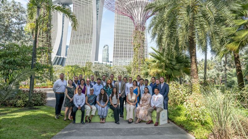 The Prince of Wales poses for a group shot with finalists at the base of the world famous ‘Supertrees’ in Gardens by the Bay, Singapore (Jordan Pettitt/PA)