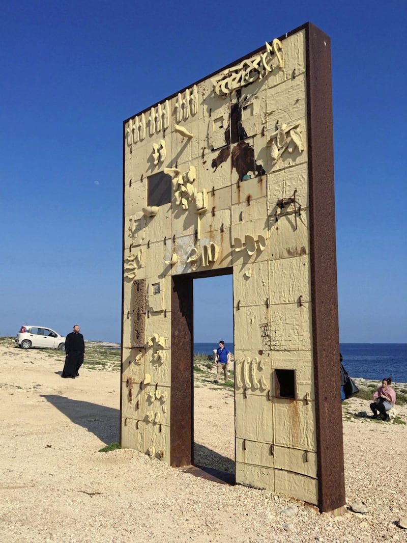 Lampedusa&#39;s Door of Europe monument. Don Carmelo La Magra, Lampedusa&#39;s priest, is in background. Picture by Alan Meban. 