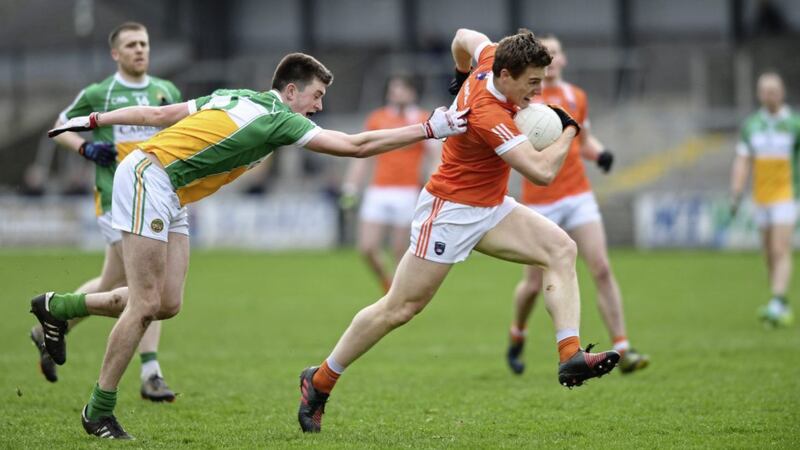 Armagh&rsquo;s Charlie Vernon escapes the clutches of James Lawlor of Offaly during yesterday&#39;s Allianz Football League Division Three match at the Athletic Grounds Picture: Ian Magennis 