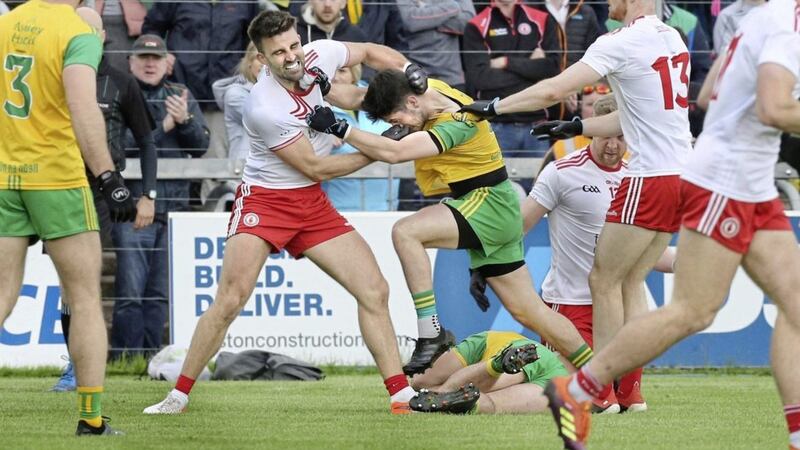 Tiernan McCann of Tyrone tangles with Ryan McHugh of Donegal after McHugh had pushed him off Stephen McMenamin who is lying on the ground. Picture Margaret McLaughlin. 