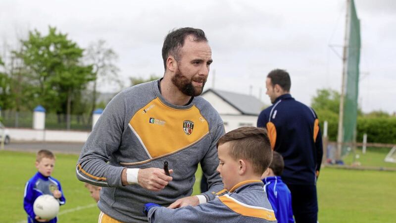 Chris Kerr signs an autograph for a young fan at the Antrim senior team&#39;s Championship launch at Tir na nOg club in Randalstown Picture by Philip Walsh. 