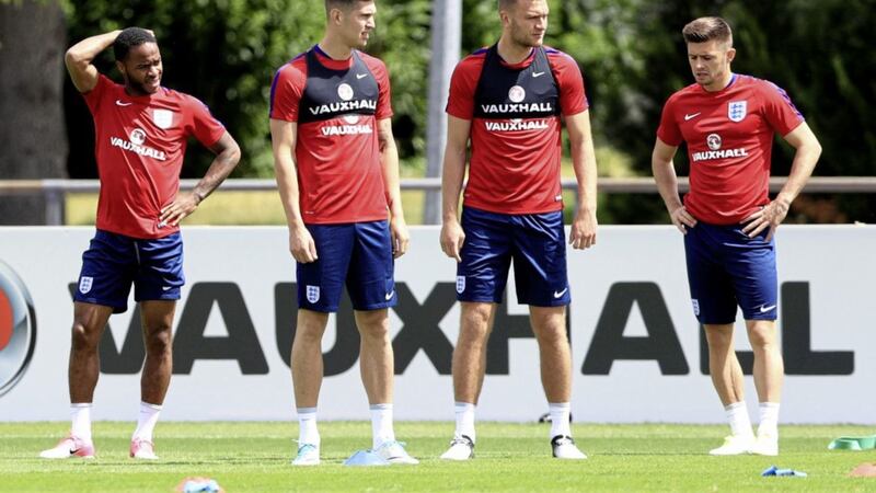 FRENCH AND SAUNTERS: England&rsquo;s players take a break during training yesterday ahead of tonight&rsquo;s friendly with France in Paris, during which John Stones (second from left) could be asked to play in an unfamiliar midfield role										         Picture: PA 
