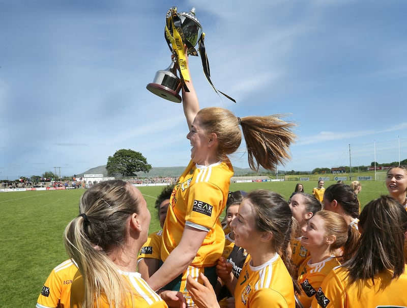 Antrim captain Cathy Carey joins the celebrations after collecting the cup for beating Tyrone in the TG4 Ulster Ladies' IFC  final at Owenbeg. Picture by Margaret McLaughlin