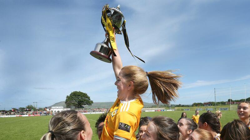 Antrim captain Cathy Carey joins the celebrations after collecting the cup for beating Tyrone in the TG4 Ulster Ladies' IFC  final at Owenbeg. Picture by Margaret McLaughlin
