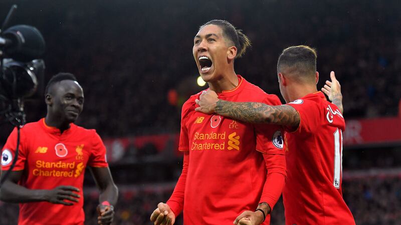 &nbsp;Liverpool's Roberto Firmino celebrates scoring his side's fourth goal of the game with Philippe Coutinho (right) during the Premier League match at Anfield. Picture by PA