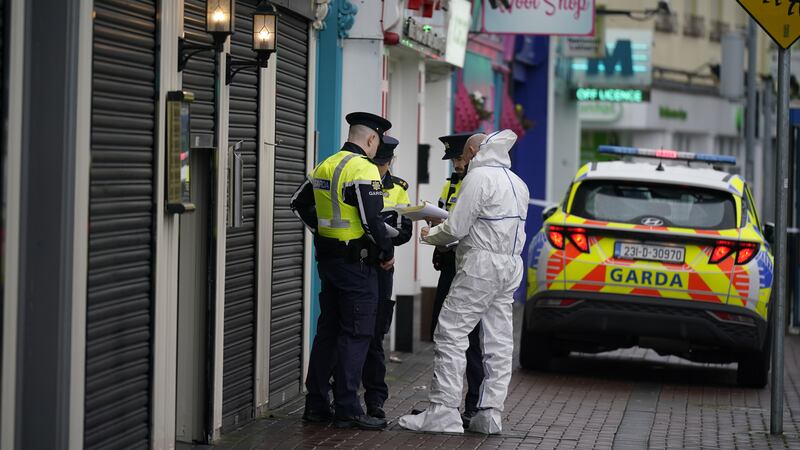 A forensic investigator speaks to garda officers at the scene at Browne’s Steakhouse restaurant