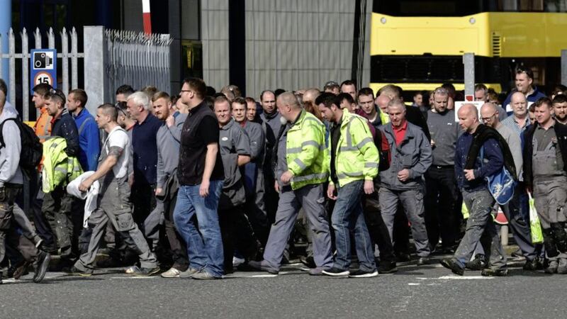 Dejected workers leave the Wrightbus plant in Ballymena after being told they were being made redundant 