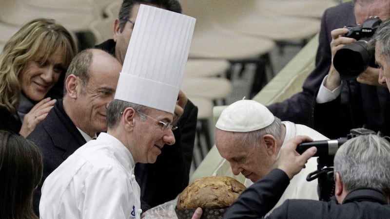 Pope Francis sniffs a Panettone &ndash; a traditional Christmas cake &ndash; during his weekly general audience, at the Vatican PictureGregorio Borgia/AP 