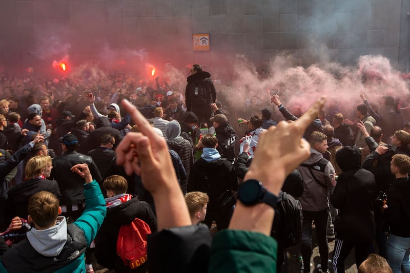 Ajax supporters celebrate outside the ArenA stadium as their team scored their second goal in the Dutch Eredivisie Premier League soccer match between Ajax and Emmen at the Johan Cruyff ArenA in Amsterdam, Netherlands