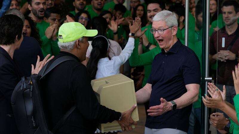 Chief executive Tim Cook posed for photos with Apple fans outside the colourful store.