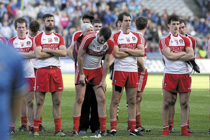 Dejected Derry players including Cailean O&#39;Boyle (bowed, centre) after losing the 2014 league final to Dublin. Picture by Colm O&#39;Reilly 